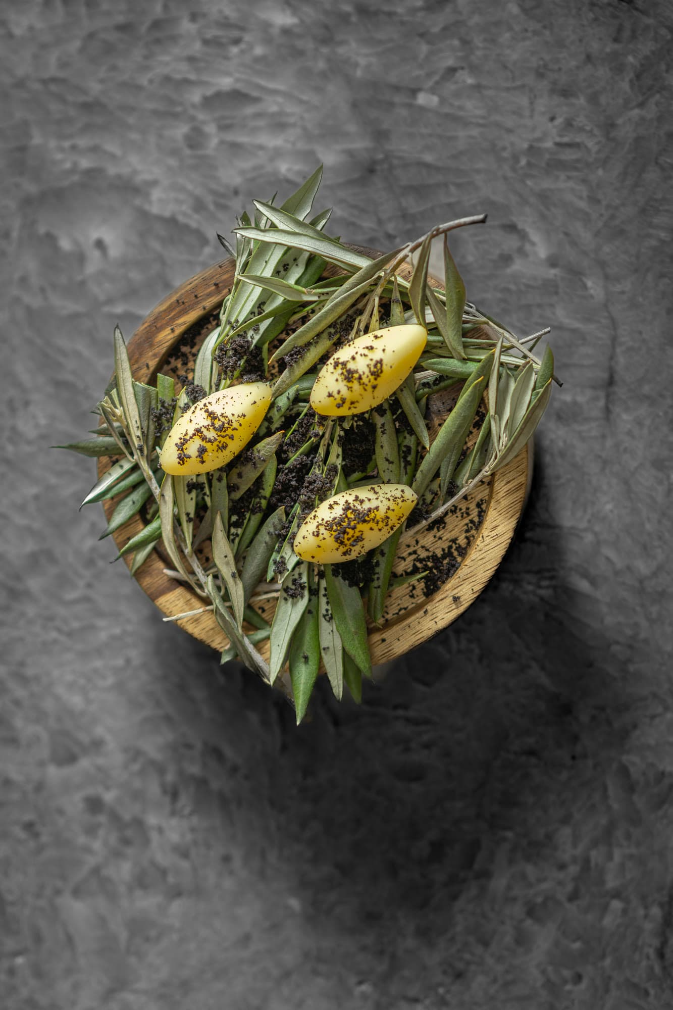 Olive-shaped yellow quenelles on olive branches